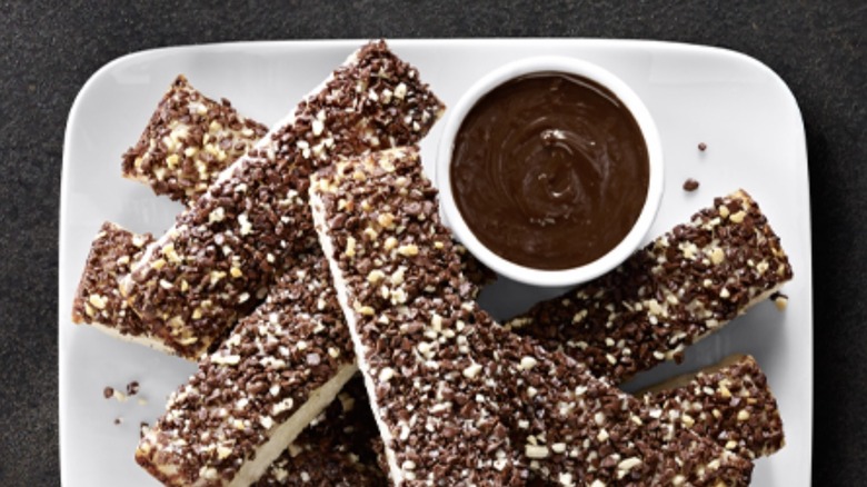Pile of Hershey's Chocolate Dunkers served on a white plate with a dish of chocolate dipping sauce