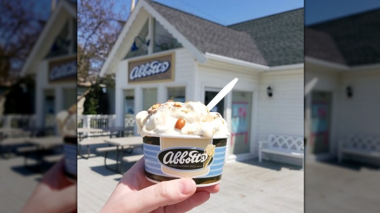 The exterior of Abbott's Frozen Custard with a scoop of ice cream in front of it