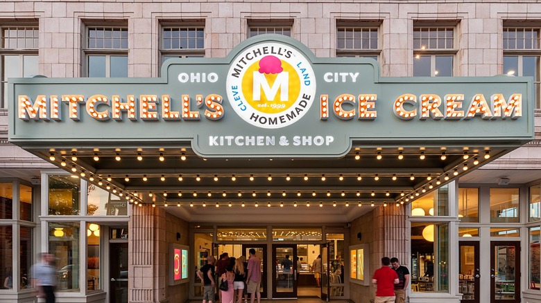 The exterior of Mitchell's, with many people outside, at night