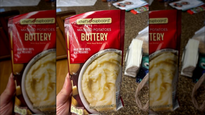 Someone holding Aldi's buttery mashed potatoes