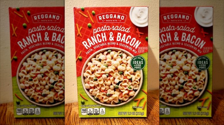 A box of Aldi's pasta salad mix sits on a wooden table