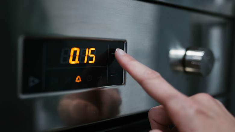 finger pressing oven button