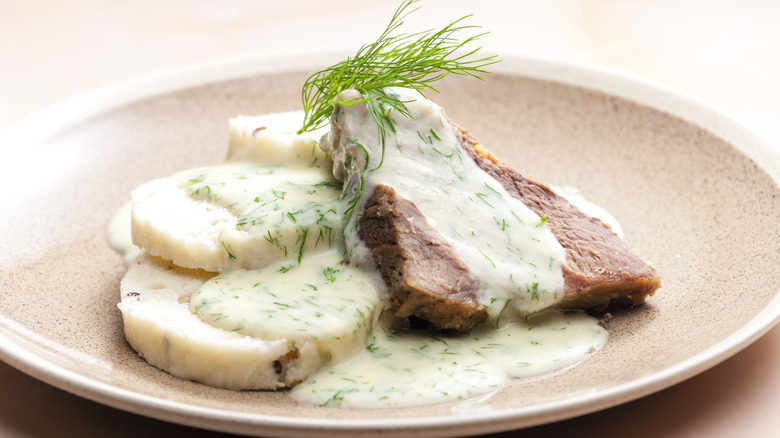 creamy dill sauce on a cut of beef