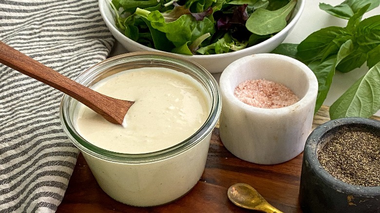 jar of sauce with wooden spoon