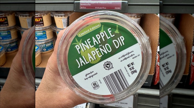 Person holds a jar of Pineapple Jalapeno dip