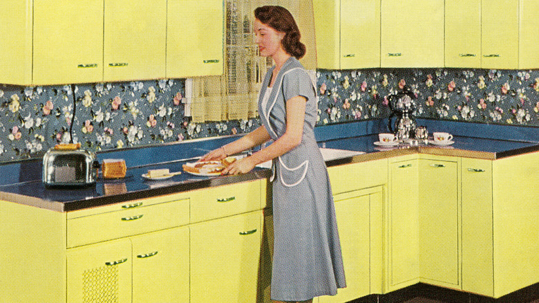 1950s advertisement of woman in kitchen with floral wallpaper