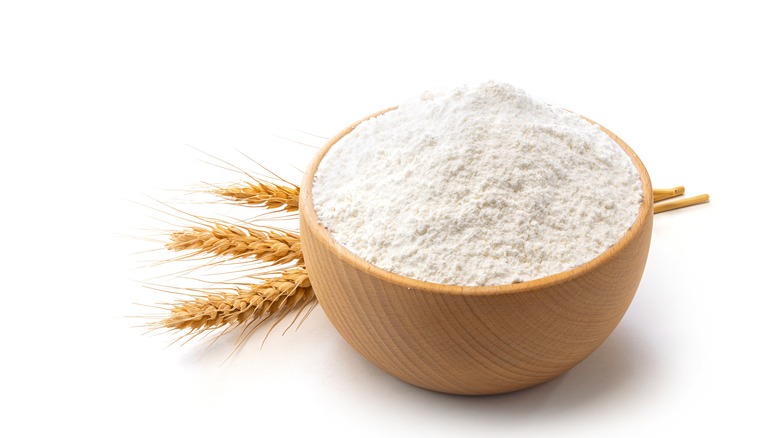 White flour in a wooden bowl