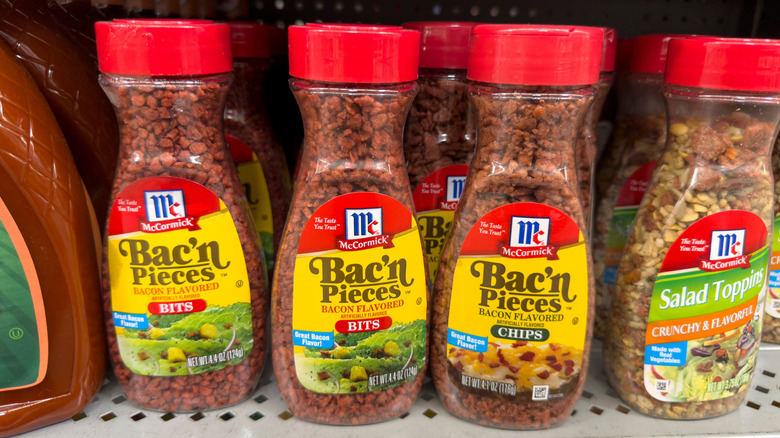 Jars of McCormick Bac'n Pieces sit on a supermarket shelf