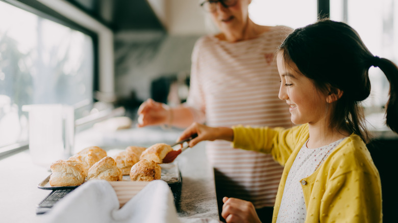 two people with freshly baked scones
