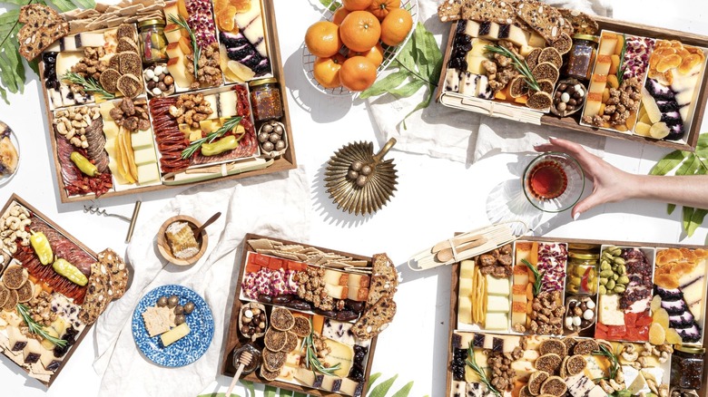 A variety of gorgeous charcuterie boards from Boarderie sit on a white table