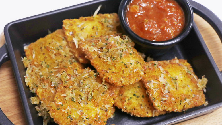 Tray of toasted ravioli with marinara sauce