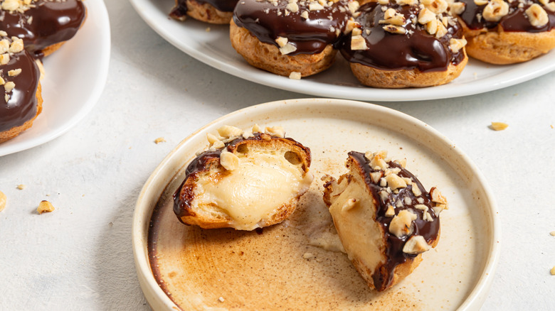 closeup halved chocolate coated profiterole