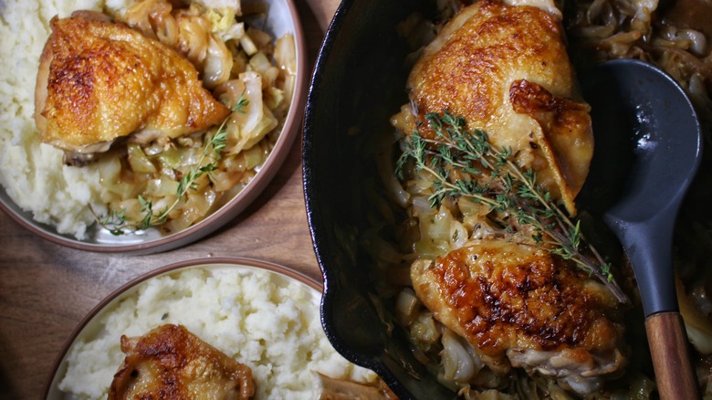 pan and plates of braised chicken