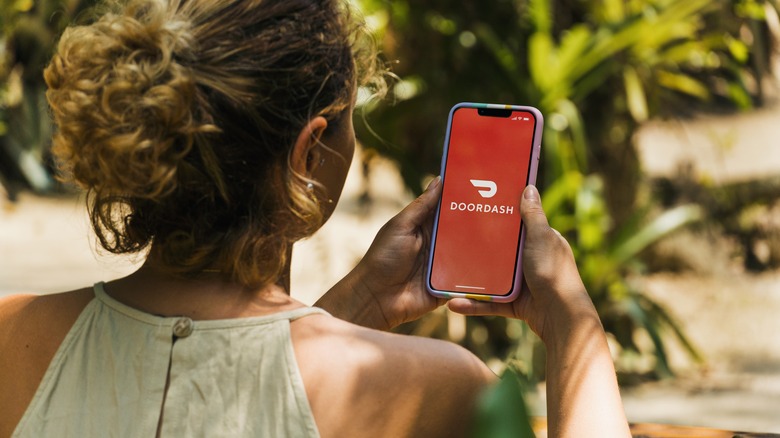 Woman looking at DoorDash app