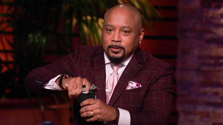 Daymond John on Shark Tank opening a beer can