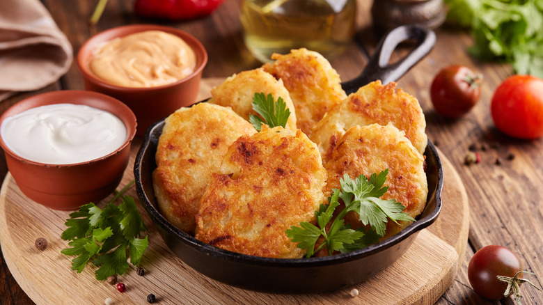 Hash browns in a skillet paired with sauces.
