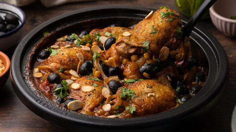Serving Moroccan-style chicken tagine 