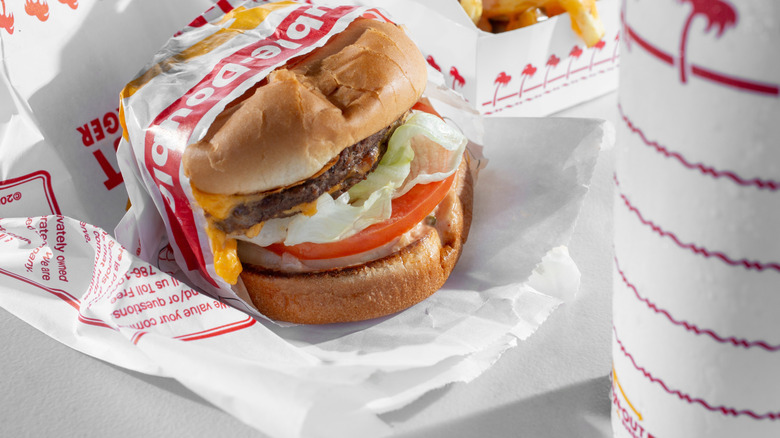 Unwrapped In-N-Out burger served with fries and a drink