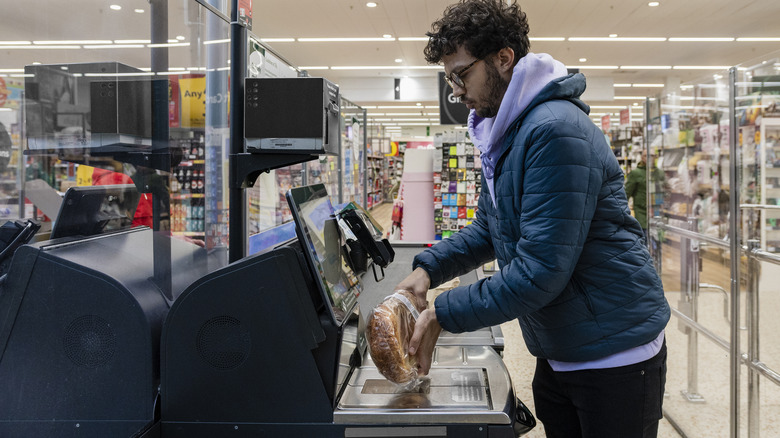 a man using the self-checkout lane