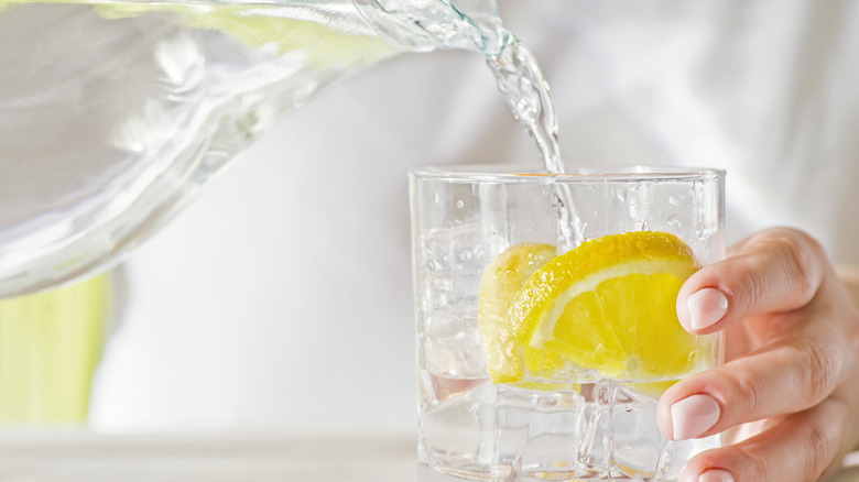 lemon water pouring into glass
