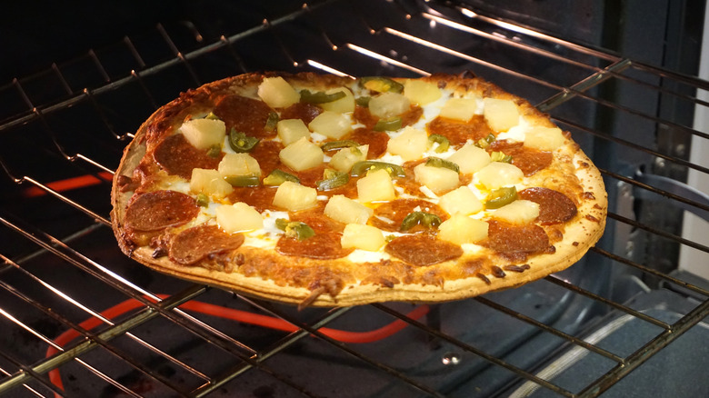 Frozen pizza on oven rack