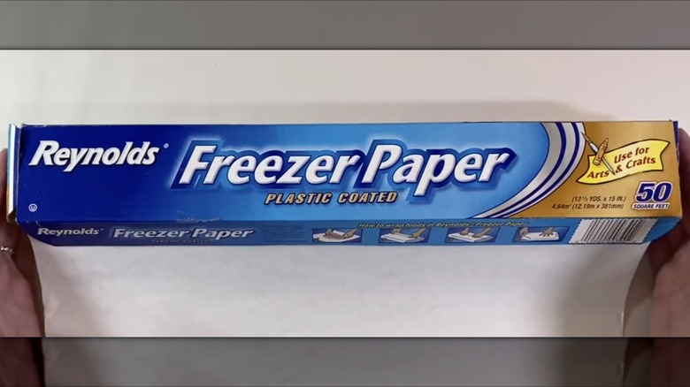Hands cradling package of Reynolds Freezer Paper