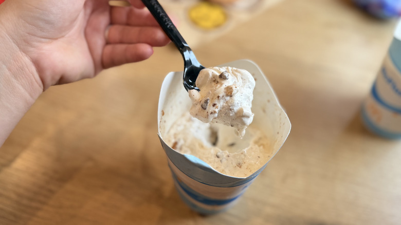 scooping McFlurry from cup