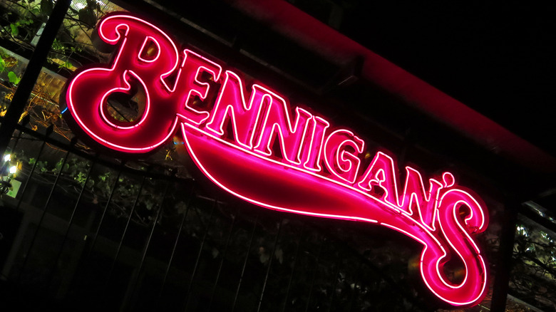 Neon Bennigan's sign glowing against a dark background