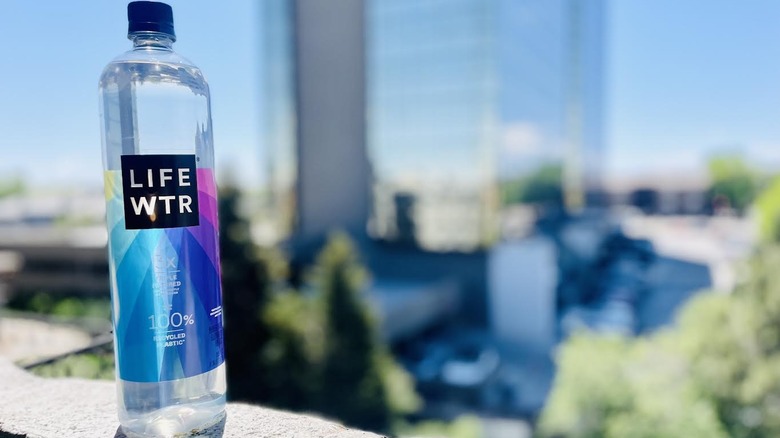 Bottle of LIFEWTR on outdoor ledge