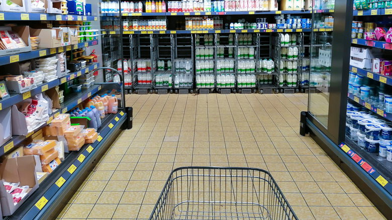 A cart is still at one end of the dairy aisle at a British Aldi