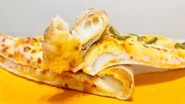 Close-up of stuffed crust on stacked pizza slices
