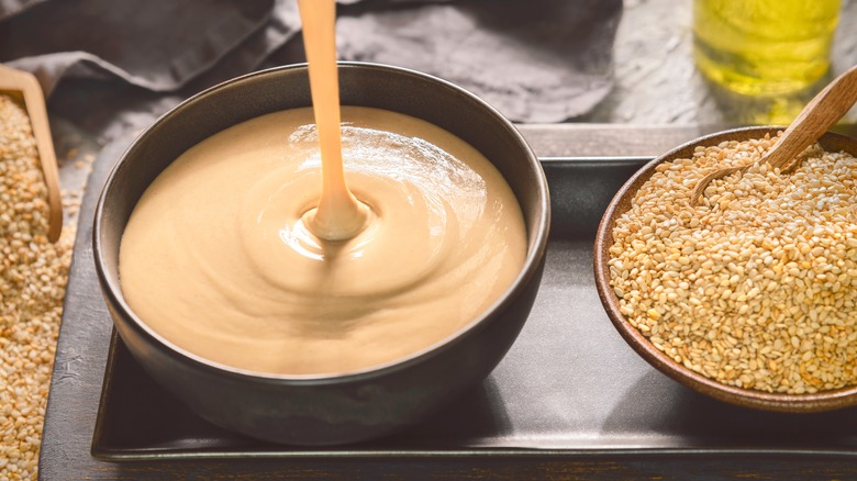 smooth tahini poured into bowl