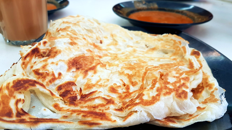 Roti prata with bowl of curry