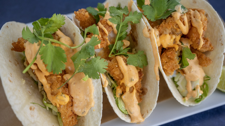 Three fish tacos sits in a row