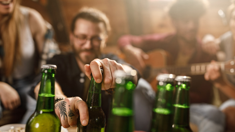 opening bottle of beer at a party