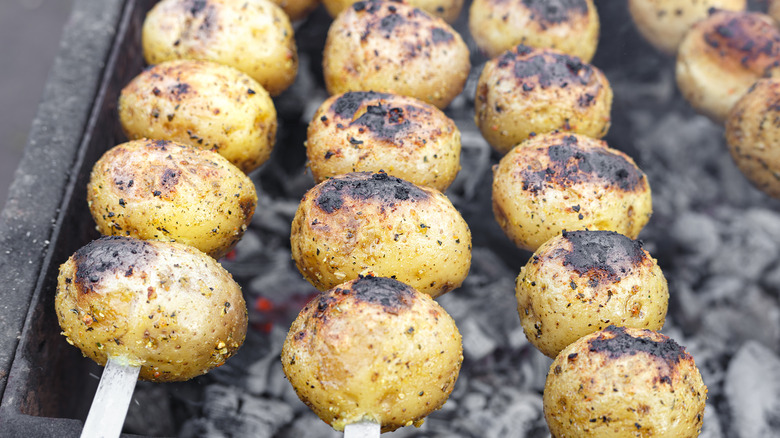 Whole potatoes on the grill