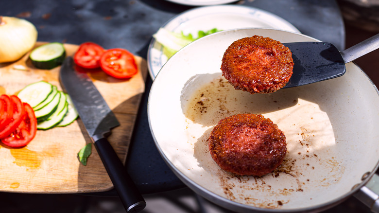 Plant-based burgers cooked in pan