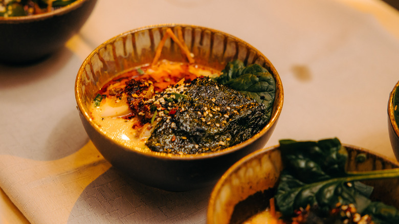 Ceramic bowl with eggs, seaweed, and sesame seeds