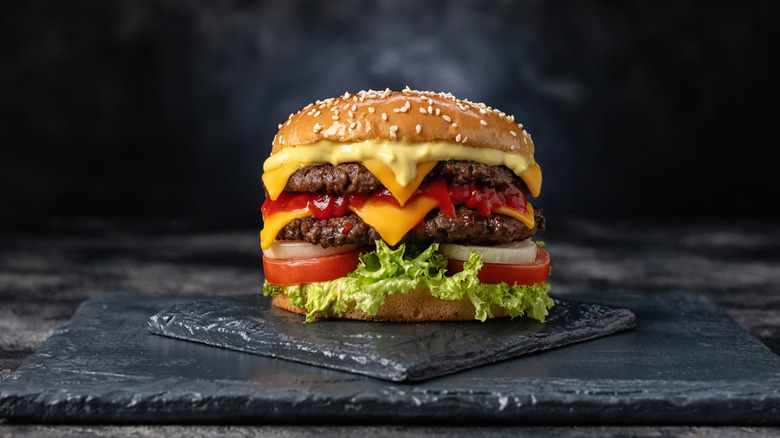 Burger dripping with melted American cheese