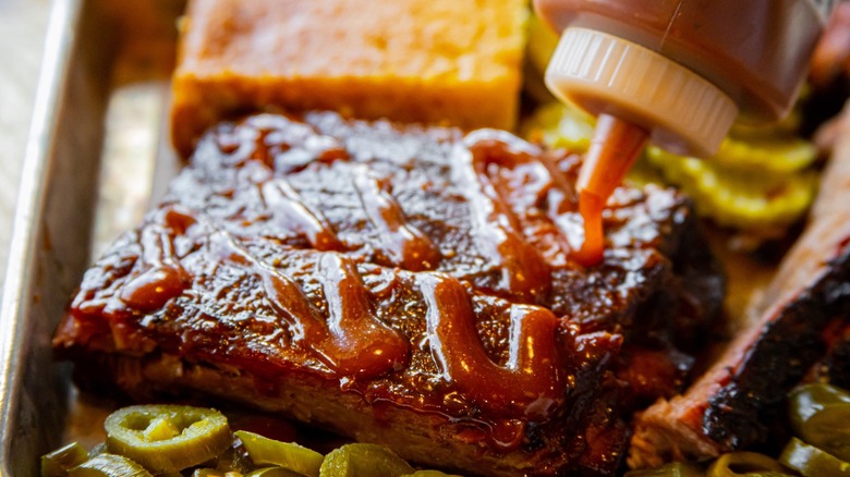 BBQ being sauced on a plate.
