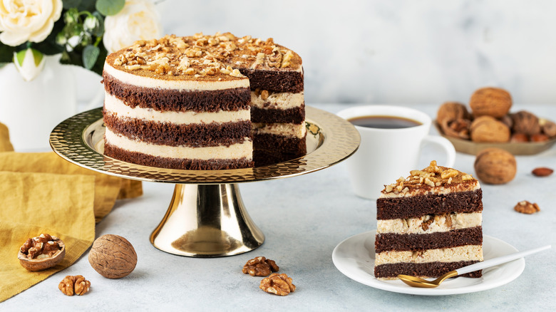 Chocolate layer cake and slice on white table