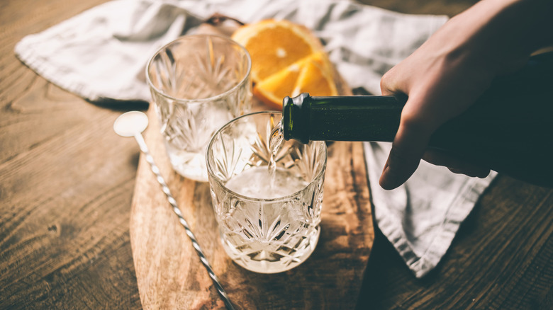 person pouring sparkling wine into a glass
