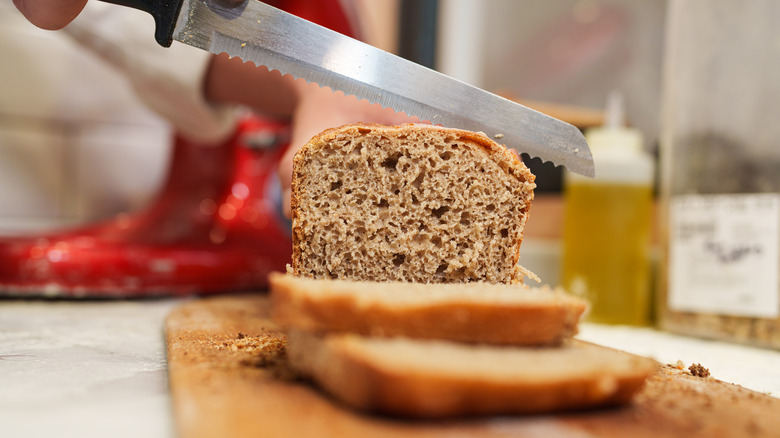 person slicing bread