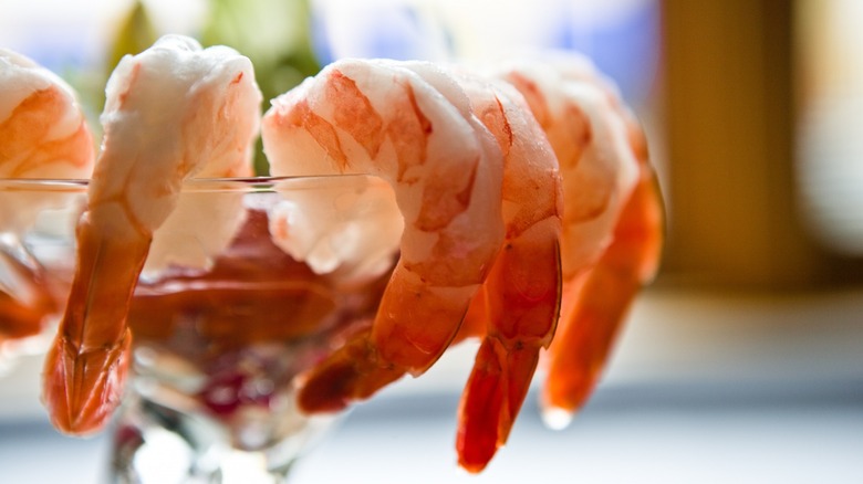 Shrimp cocktail around glass