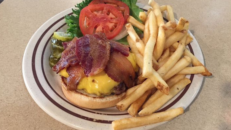 The Bacon Cheeseburger on a plate with fries