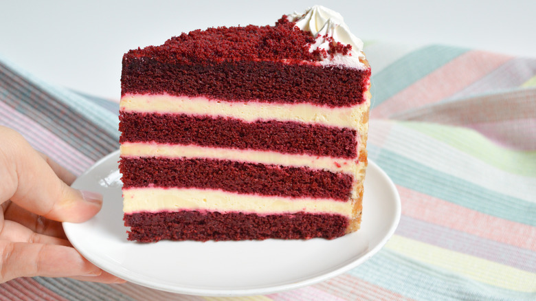 Slice of red velvet cake on plate.
