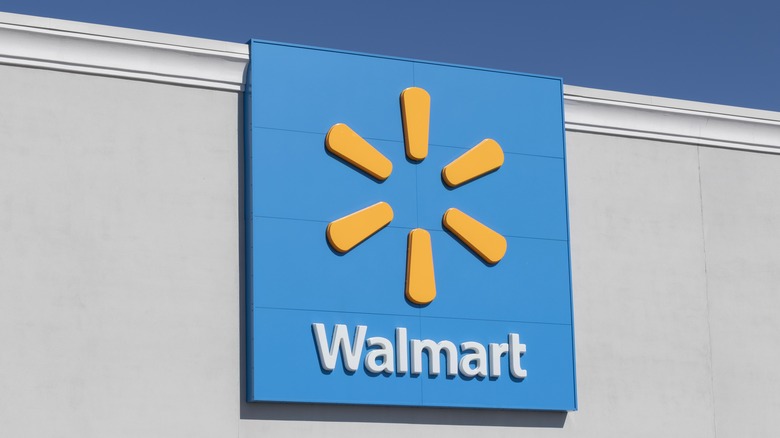 Walmart's yellow spark logo on blue backdrop attached to a building exterior