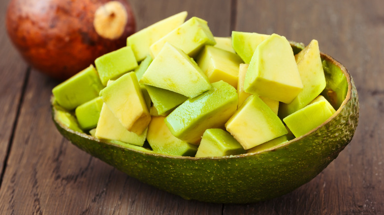 Chopped avocado on wood background