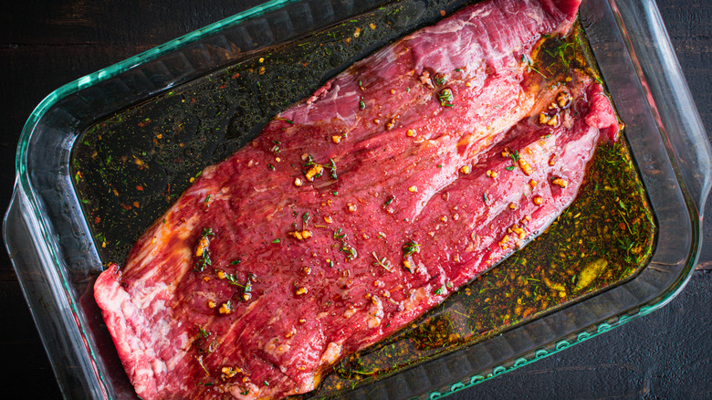 Steak marinating in a tray