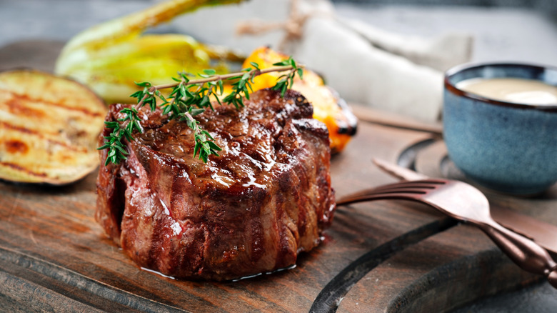 Filet steak on wooden board